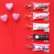 Load image into Gallery viewer, Rainbow Hearts on Black LippyClip® Lip Balm Holder